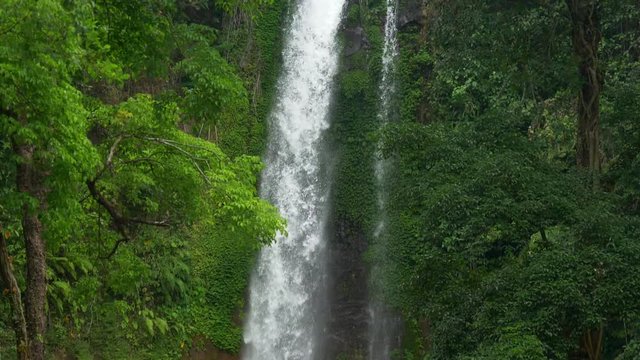 Gitgit waterfall on Bali island, Indonesia. Slow motion tilt shot