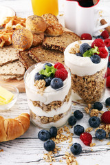 Breakfast served with coffee, orange juice, bread, parfaits and fruits. Balanced diet