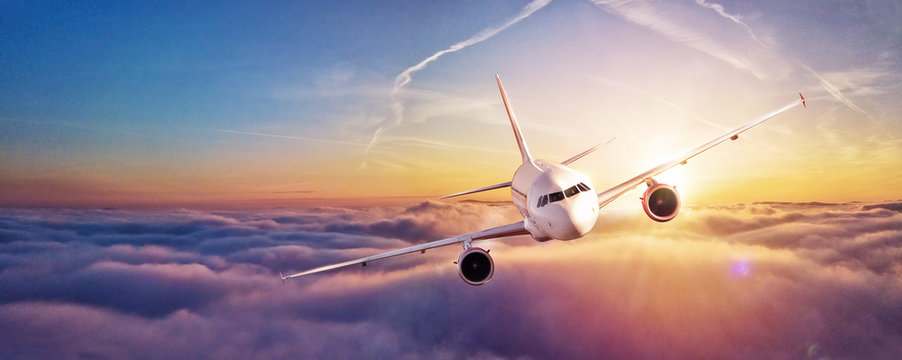 Fototapeta Commercial airplane flying above clouds