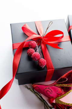 Black christmas  gift  box with red ribbon and nask