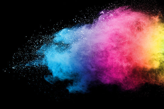 Splash of colorful powder over black background.
