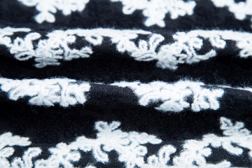 black-and-white warm fleecy fabric with a white pattern on a black background
