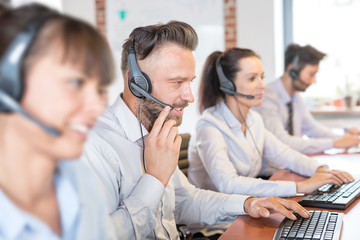 Call center worker accompanied by his team.