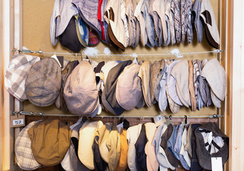 Flat hats hanging on the wall in the shopping mall