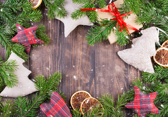 Border, frame from christmas tree branches with pine cones and holly berries