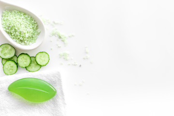 Fresh organic cosmetics with cucumber. Cream, lotion, spa salt on white background top view copyspace