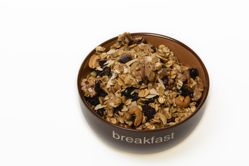 granola with nuts and crandberry close up isolated on white background.