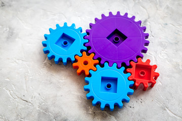 bright gears for great technology of team work and correct mechanism on stone background