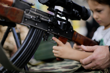 Little boy with assault rifle