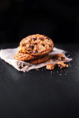 Chocolate chip cookies on dark table with copy  place for text