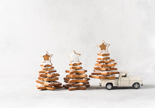 Christmas card with three gingerbread fir and one of them on car