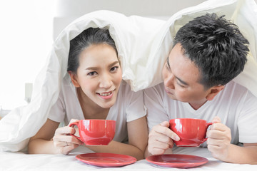 Couples having breakfast on bed