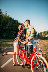 Love couple with vintage bicycle walking in park