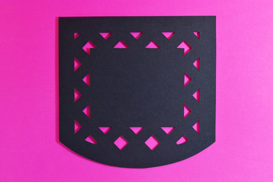 dark mexican perforated paper on pink background