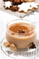 cup of hot spicy masala tea and Christmas cookies on white background, vertical closeup