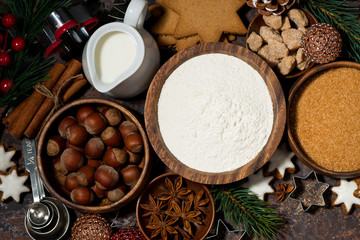 ingredients for Christmas baking on dark background, top view