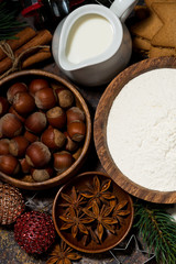 ingredients for Christmas baking on dark background, vertical closeup