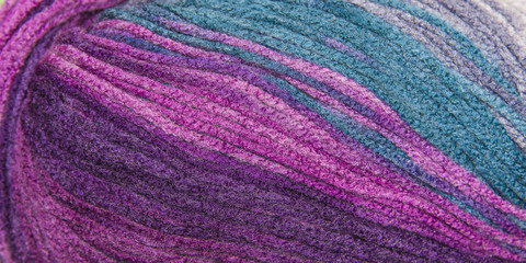 background thread for knitting. Knitting pattern of colorful yarn wool.