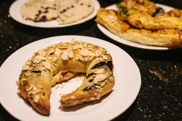 Turkish sweets - sweet bagel with filling sprinkled with pieces of nuts