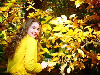 Autumn beautiful girl in the yellow forest. Woman spending holidays out of the city. People inspired by nature. Girl with yellow leaves. Autumn magic forest on the sunny day. Girl on the nature.