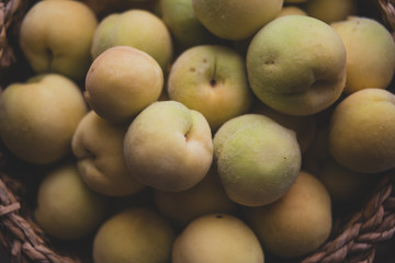 Pile of vineyard peach in wooden basket
