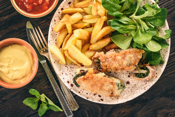 Pork roulades with spinach and cheese filling, served with fried potatoes.
