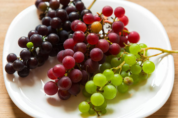 Three bunches of grapes on a plate