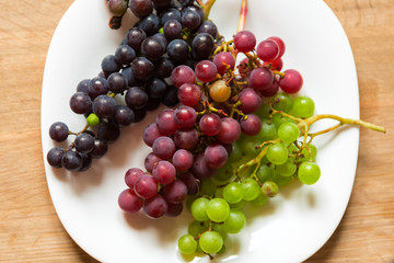 Three bunches of grapes on a plate