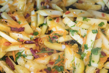 Fried potatoes with vegetables and sausages. Top view