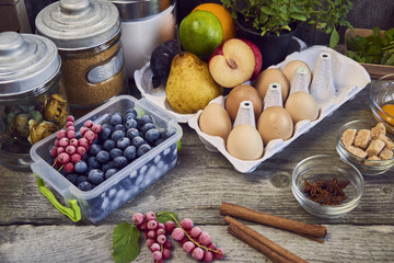 Food ingredients and kitchen utensils for cooking desserts on wooden background