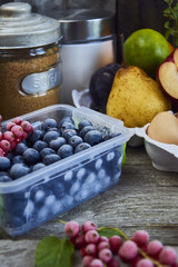 Food ingredients and kitchen utensils for cooking desserts on wooden background