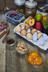 Food ingredients and kitchen utensils for cooking desserts on wooden background