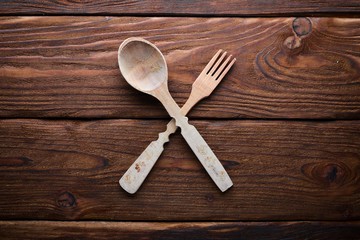 Kitchen wooden appliances on a wooden surface. Top view. Free space for your text.