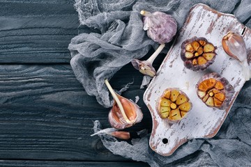 Garlic. On a wooden background. Top view. Free space for your text.