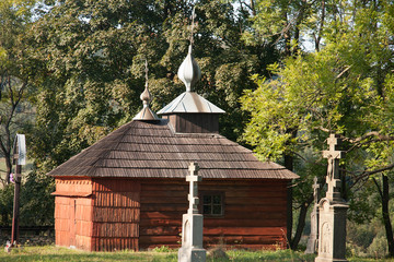 standing in the middle of the hills; surrounded by old stone crosses the chapel - the repository in Regetow