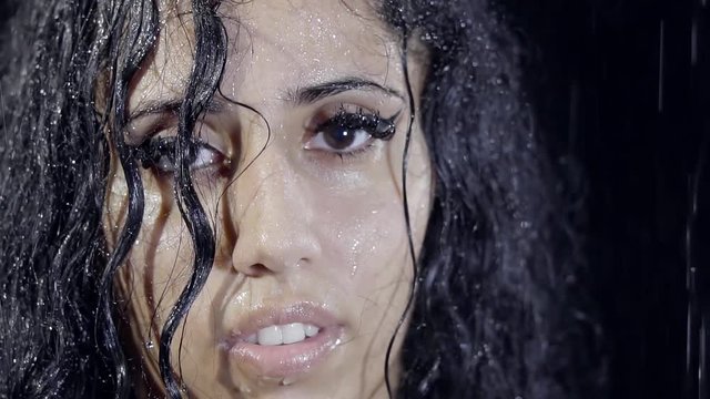 Close-up. Portrait Of A Cute Arab Girl With Long Curly Black Hair In The Rain