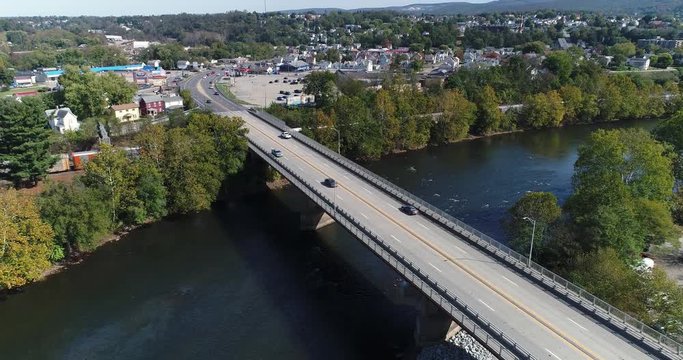 A slowly rising aerial shot of the small town of Connellsville, Pennsylvania while traffic travels on the Memorial Boulevard (Rt 119) bridge over the Youghiogheny River.	 	