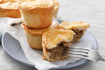 Delicious little meat pies on plate