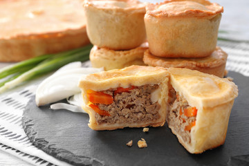 Delicious little meat pies on slate plate
