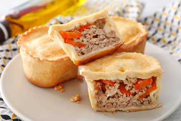 Delicious little meat pies on plate