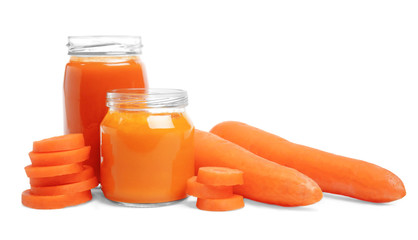 Jars with baby food on white background