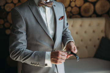 Businessman checking time on his wristwatch. men's hand with a watch.