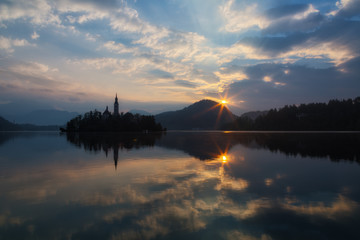 Fototapeta na wymiar Church on island in Lake Bled n sunrise, Slovenia