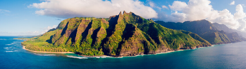 Amazing aerial view of the Na Pali coast cliffs from above. Beautiful Pacific ocean, sunlight and green cliffs of the Hawaii islands.  © Aerial Film Studio