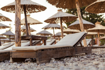 sunbeds and straw umbrellas on beach