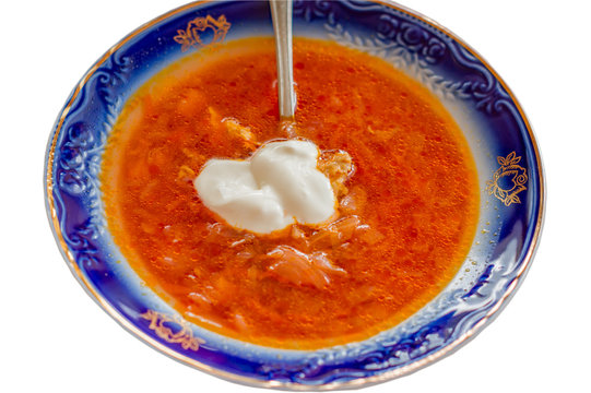 blate of borscht with sauce cream isolated on white background