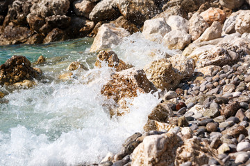 waves break against the rocks 