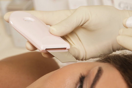 Woman During Ultrasonic Facial Cleansing Procedure