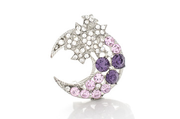 silver brooch month with stars with diamonds isolated on white