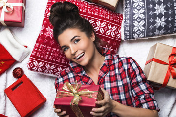 Happy woman with a lot of Christmas gifts